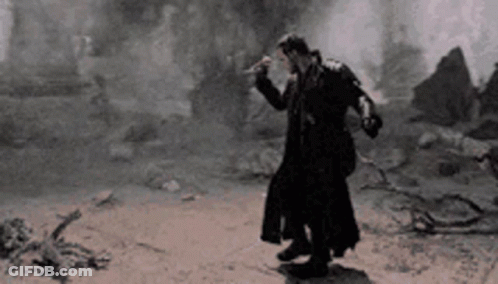 Man In Trench Coat On Dirt Road GIF