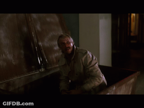 Man In Trench Coat Standing By Wall GIF