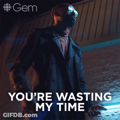 Man In Trench Coat Standing In Front Of Sign Saying You're Wasting My Time GIF