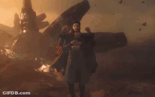 Man In Trench Coat Surrounded By Arms GIF