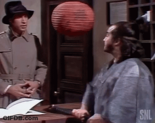 Man In Trench Coat Talking To Man In Kimono GIF