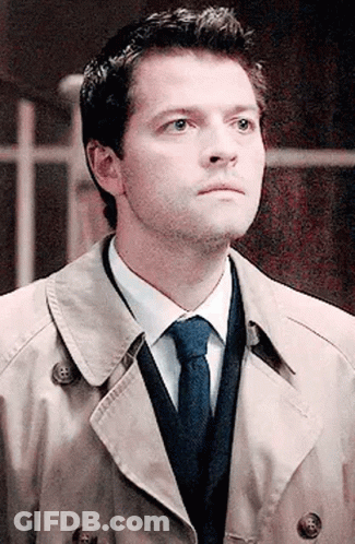 Man In Trench Coat Tie And Sweater Looking Up GIF