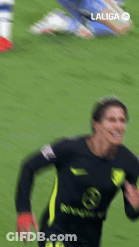 Man In Trench Coat Walking On Soccer Field Surrounded By Security Guards GIF