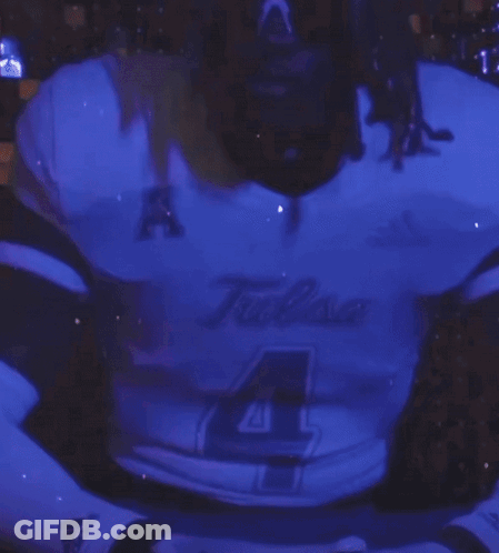 Man In Tulsa Jersey Standing In Front Of Purple Background GIF