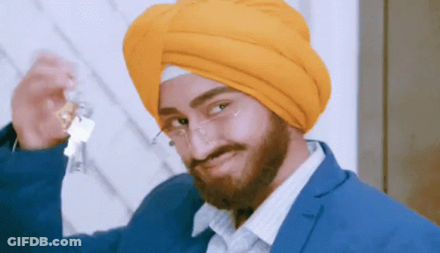 Man In Turban And Glasses Holding Bottle GIF