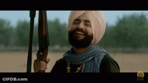 Man In Turban Holding Gun Smiling GIF