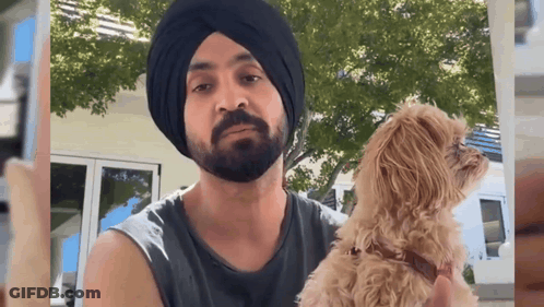 Man In Turban Holding Small Dog GIF