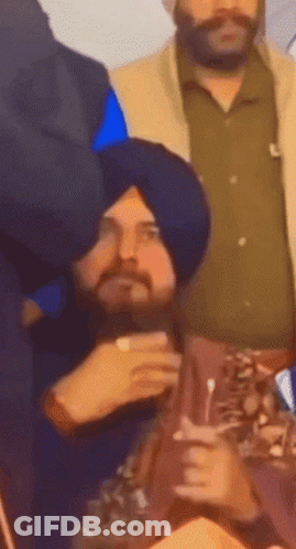 Man In Turban Sitting In Crowd GIF