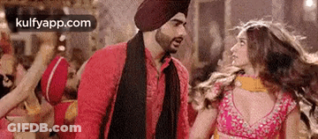 Man In Turban Talking To Woman In Pink Dress GIF