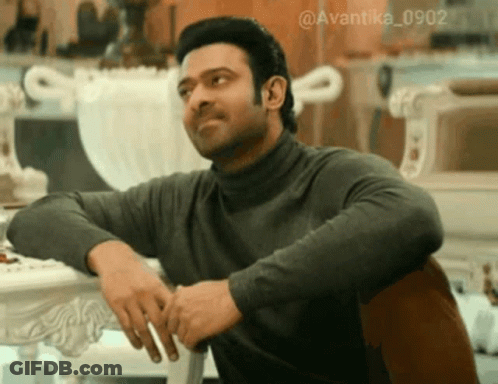 Man In Turtleneck Sitting With Hands On Hips GIF