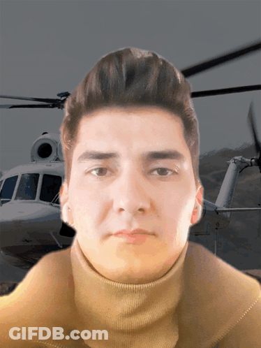 Man In Turtleneck Standing In Front Of Helicopter GIF