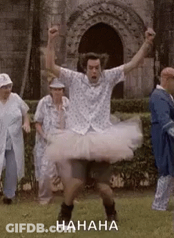 Man In Tutu Dancing In Field With Group GIF