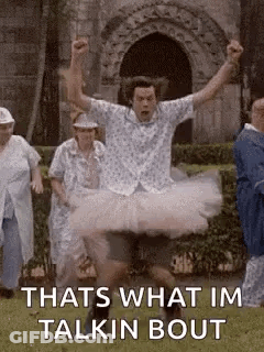 Man In Tutu Jumping In Air While Group Watches GIF