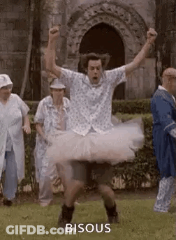 Man In Tutu Jumping While Group Watches GIF