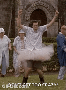 Man In Tutu Jumping While People Watch GIF