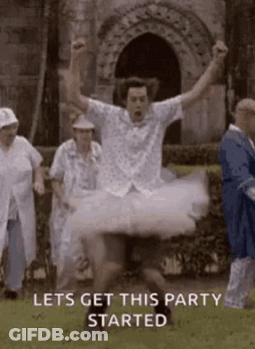 Man In Tutu Jumping With Arms In Air GIF