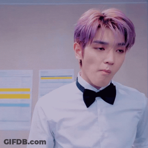 Man In Tuxedo Adjusting Bow Tie In Front Of Disney Plus Sign GIF