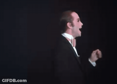 Man In Tuxedo And Bow Tie At Podium GIF