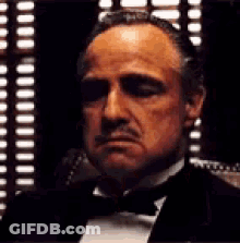Man In Tuxedo And Bow Tie By Window GIF