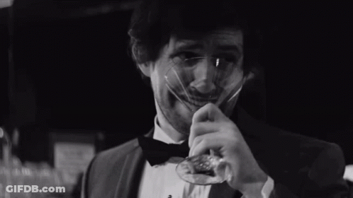 Man In Tuxedo And Bow Tie Holding Glass GIF