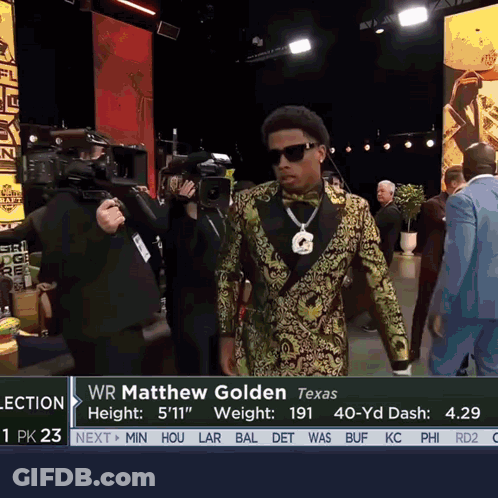 Man In Tuxedo And Bow Tie In Front Of Wr Matthew Golden Sign GIF