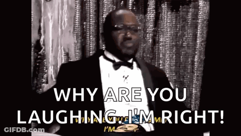 Man In Tuxedo And Bow Tie Laughing Holding Paper GIF