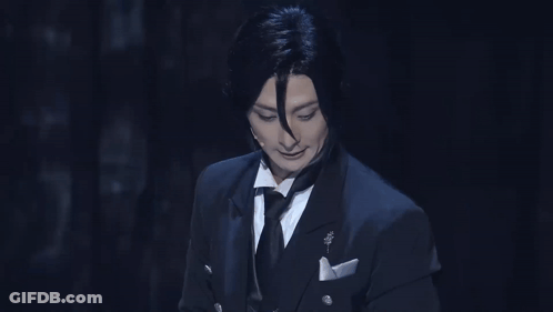 Man In Tuxedo And Bow Tie Looking Down GIF