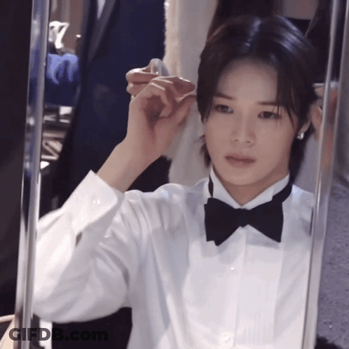 Man In Tuxedo And Bow Tie Looking In Mirror GIF