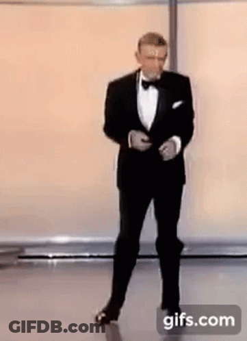 Man In Tuxedo And Bow Tie On Stage GIF