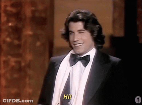Man In Tuxedo And Bow Tie Saying Hi GIF