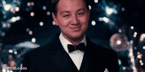 Man In Tuxedo And Bow Tie Smiles GIF