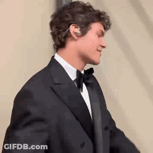 Man In Tuxedo And Bow Tie Smiling GIF