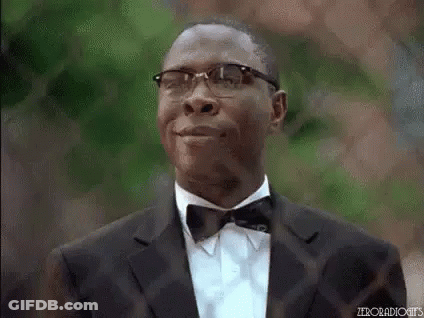 Man In Tuxedo And Bow Tie Smiling With Glasses GIF