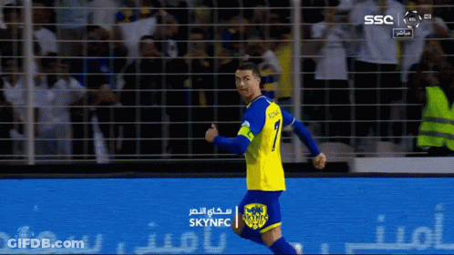 Man In Tuxedo And Bow Tie Waving Soccer Ball GIF