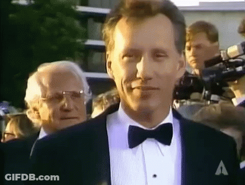 Man In Tuxedo And Bow Tie With A On Jacket GIF