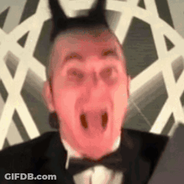 Man In Tuxedo And Bow Tie With Devil Horns GIF