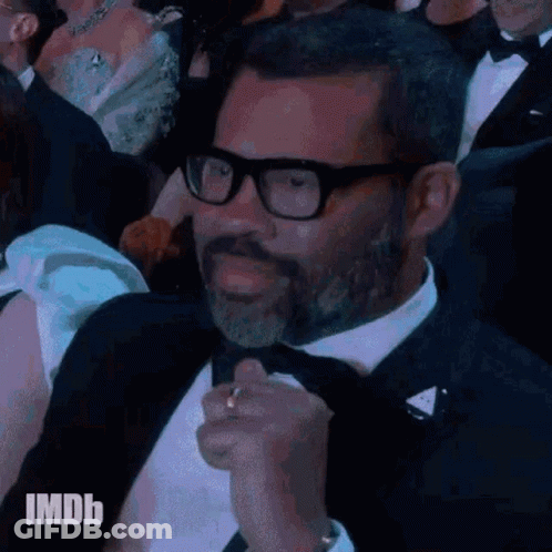 Man In Tuxedo And Glasses At Event GIF