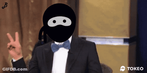 Man In Tuxedo And Ninja Mask Giving Peace Sign GIF