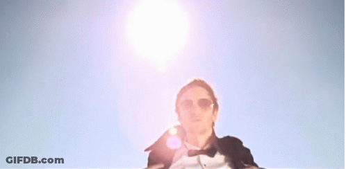 Man In Tuxedo And Shorts On Boat With Arms Outstretched GIF