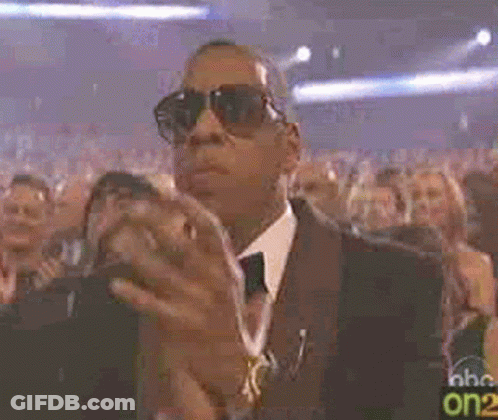 Man In Tuxedo And Sunglasses Clapping In Crowd GIF