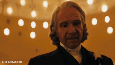 Man In Tuxedo And Tie In Front Of Chandelier GIF
