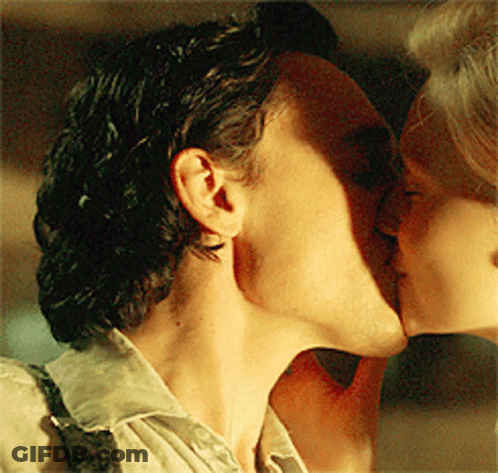 Man In Tuxedo And Woman In Black Dress Kissing GIF