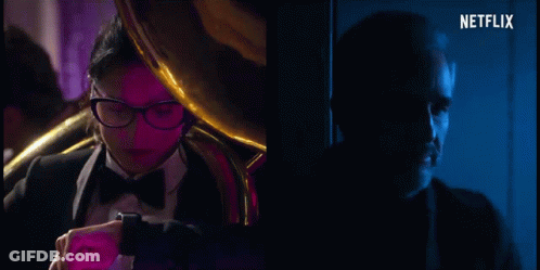 Man In Tuxedo And Woman In Black Turtleneck Netflix Ad GIF