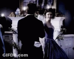 Man In Tuxedo And Woman In Blue Dress Dancing GIF