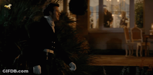 Man In Tuxedo And Woman In Blue Dress Looking At Each Other GIF