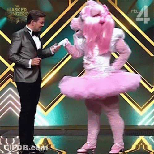 Man In Tuxedo And Woman In Pink Ballerina Costume GIF