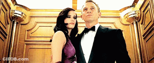 Man In Tuxedo And Woman In Purple Dress GIF