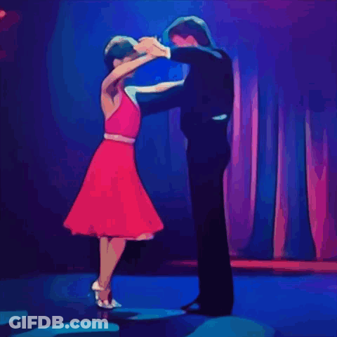 Man In Tuxedo And Woman In Red Dress Dancing GIF