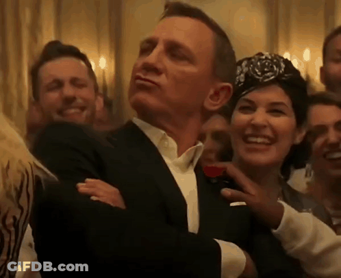 Man In Tuxedo And Woman In Turban GIF