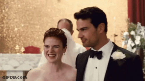 Man In Tuxedo And Woman In Wedding Dress Smiling GIF